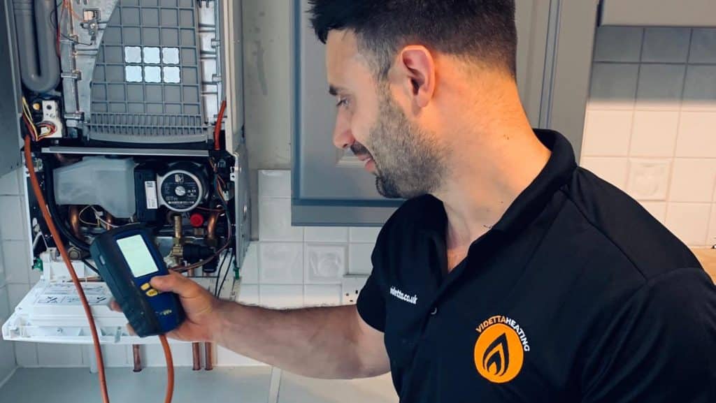 engineer servicing boiler